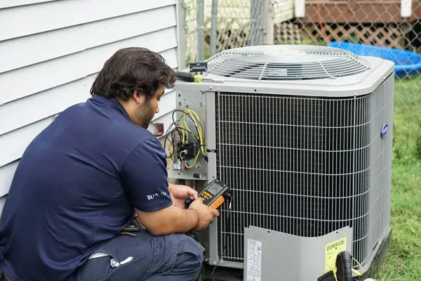 Technician testing a new outdoor AC unit